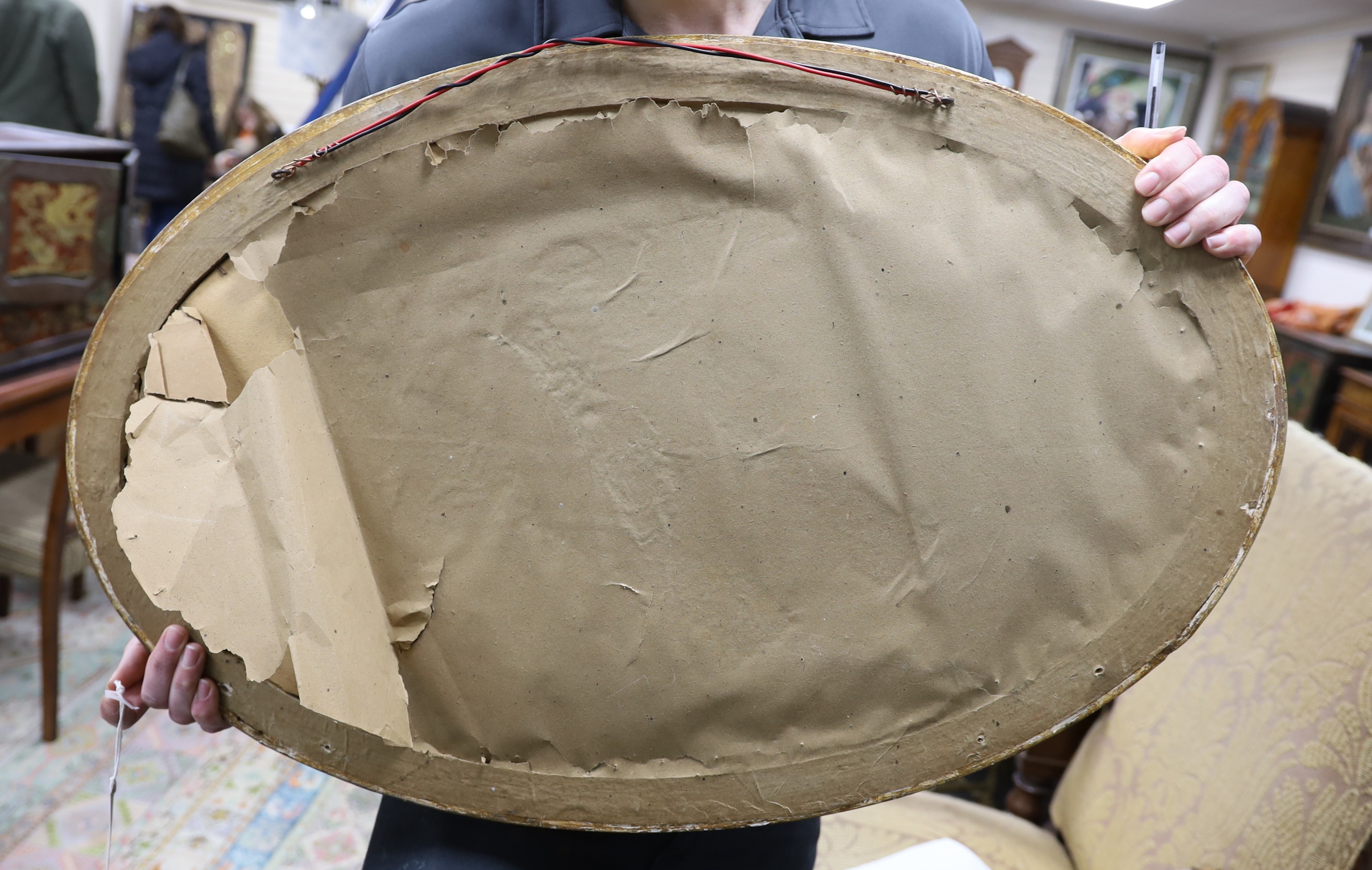 An oval moulded gilt wall mirror width 86cm, height 56cm.